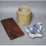 A Chinese blue and white Ming porcelain finial, a leather wallet. c.1920 and a cream stone cylinder,