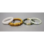 Four Chinese jade or hardstone bangles