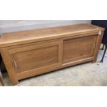 A contemporary light oak sliding door sideboard, length 178cm, depth 50cm, height 78cm