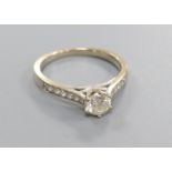 A diamond solitaire ring with diamond-set shoulders, 18ct white gold setting, size L, gross 3.2