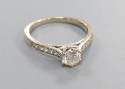 A diamond solitaire ring with diamond-set shoulders, 18ct white gold setting, size L, gross 3.2