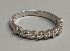 A modern 18ct white gold and nine stone diamond set half eternity ring, size N, gross 3 grams.