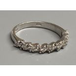 A modern 18ct white gold and nine stone diamond set half eternity ring, size N, gross 3 grams.