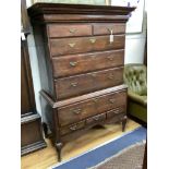 An 18th century cross banded oak chest on stand, width 116cm, depth 57cm, height 170cm