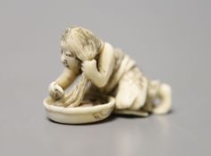 A 19th century Japanese ivory netsuke of a woman washing her hair, 3.5cm wide