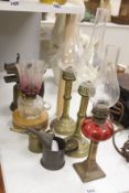 A pair of candle storm lamps, two oil lamps, a paint stripper, a jeweller's blow lamp and oil can,