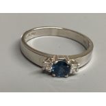 A modern 18ct white gold, sapphire and diamond set three stone ring, size N/O, gross 3.2 grams.