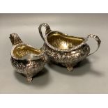 A George the fourth embossed silver cream jug and to handle sugar bowl by Hyam Hyams, London 1824,