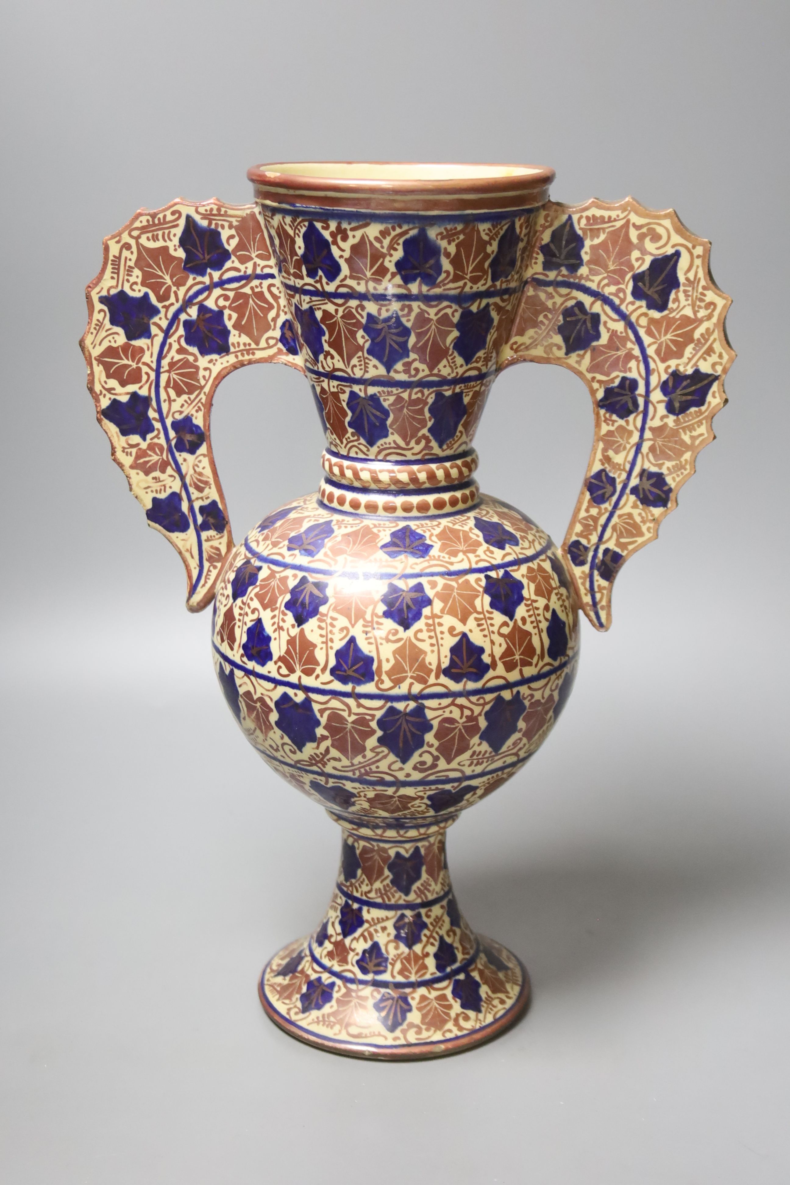 A Persian copper lustre two handled vase