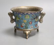 A heavy Chinese silvered bronze twin handled censer with floral decoration, a four character