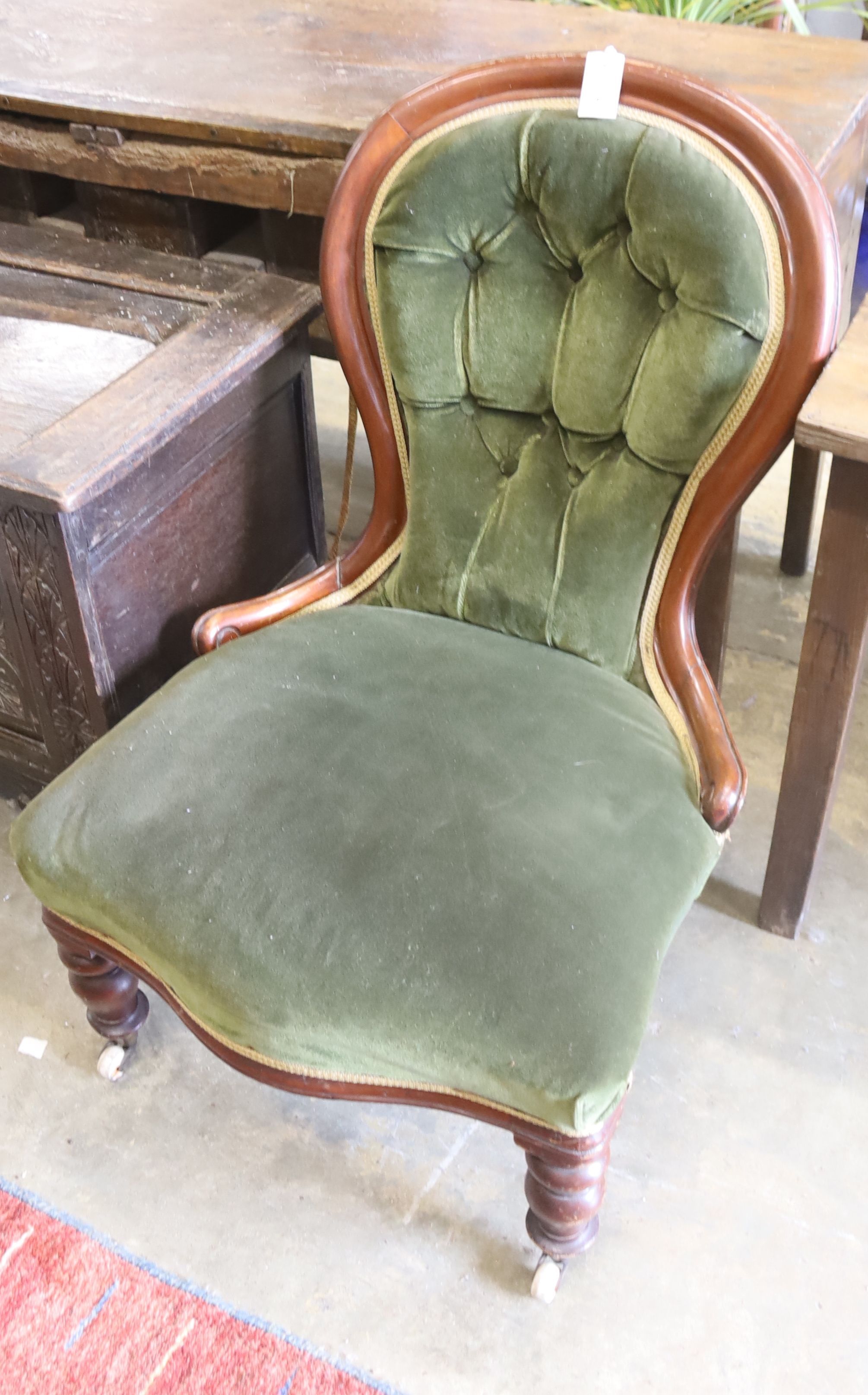 A Victorian mahogany spoon back nursing chair