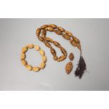 A coquilla nut necklace, bracelet and two small ornamental carvings