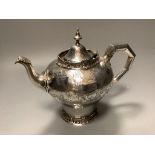 A Victorian silver teapotof inverted baluster form and having engraved swag, scrolled and foliate