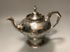 A Victorian silver teapotof inverted baluster form and having engraved swag, scrolled and foliate