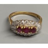 A modern 18ct gold, ruby and diamond set ovoid cluster ring, size M, gross 4.4 grams.