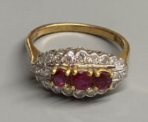 A modern 18ct gold, ruby and diamond set ovoid cluster ring, size M, gross 4.4 grams.