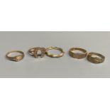 Five assorted modern 9ct gold rings, including two buckle rings and a horseshoe ring,10.7 grams.