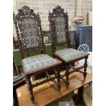 A pair of late 19th century Flemish carved oak panel backed dining chairs