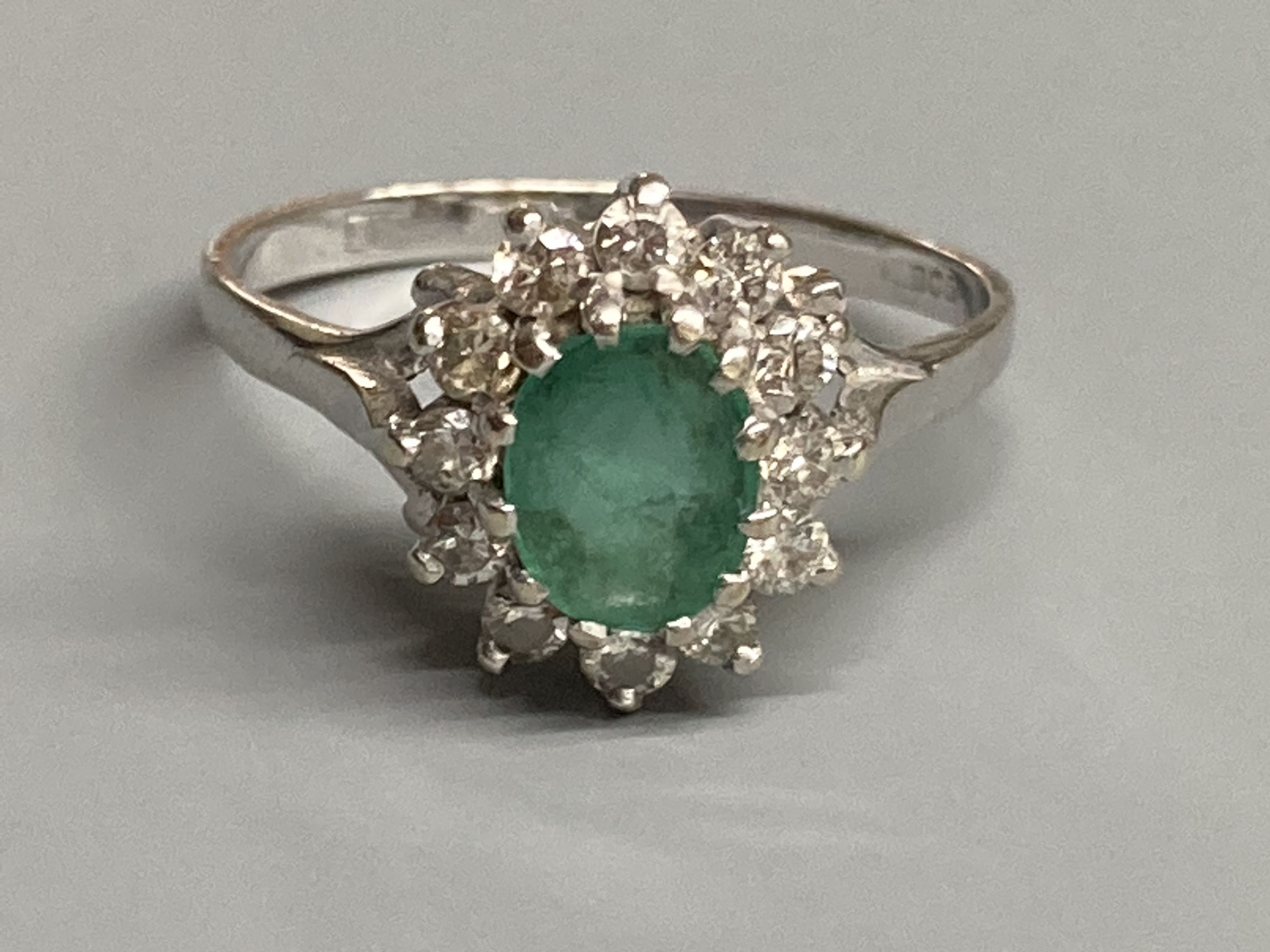 A modern 18ct white gold, emerald and diamond set oval cluster ring, size O/P, gross 3.6 grams. - Image 2 of 3