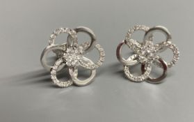 A modern pair of 18ct white gold and diamond cluster set openwork flower head ear studs, diameter