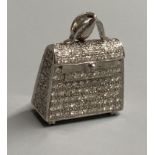 A modern 18k 750 white metal and diamond encrusted handbag charm, with diamond set bale and four