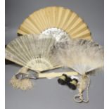 An ivory page turner with embossed white metal handle, a pair of opera glasses and three fans,