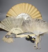 An ivory page turner with embossed white metal handle, a pair of opera glasses and three fans,