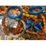 A small quantity of assorted costume jewellery including amber necklace.