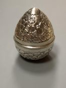 A 20th century Egyptian white metal embossed box and cover, modelled as an egg, post 1946 mark,