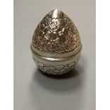 A 20th century Egyptian white metal embossed box and cover, modelled as an egg, post 1946 mark,