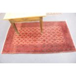 A Belouch red ground rug, 200 x 115cm