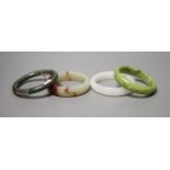 Four Chinese jade or hardstone bangles