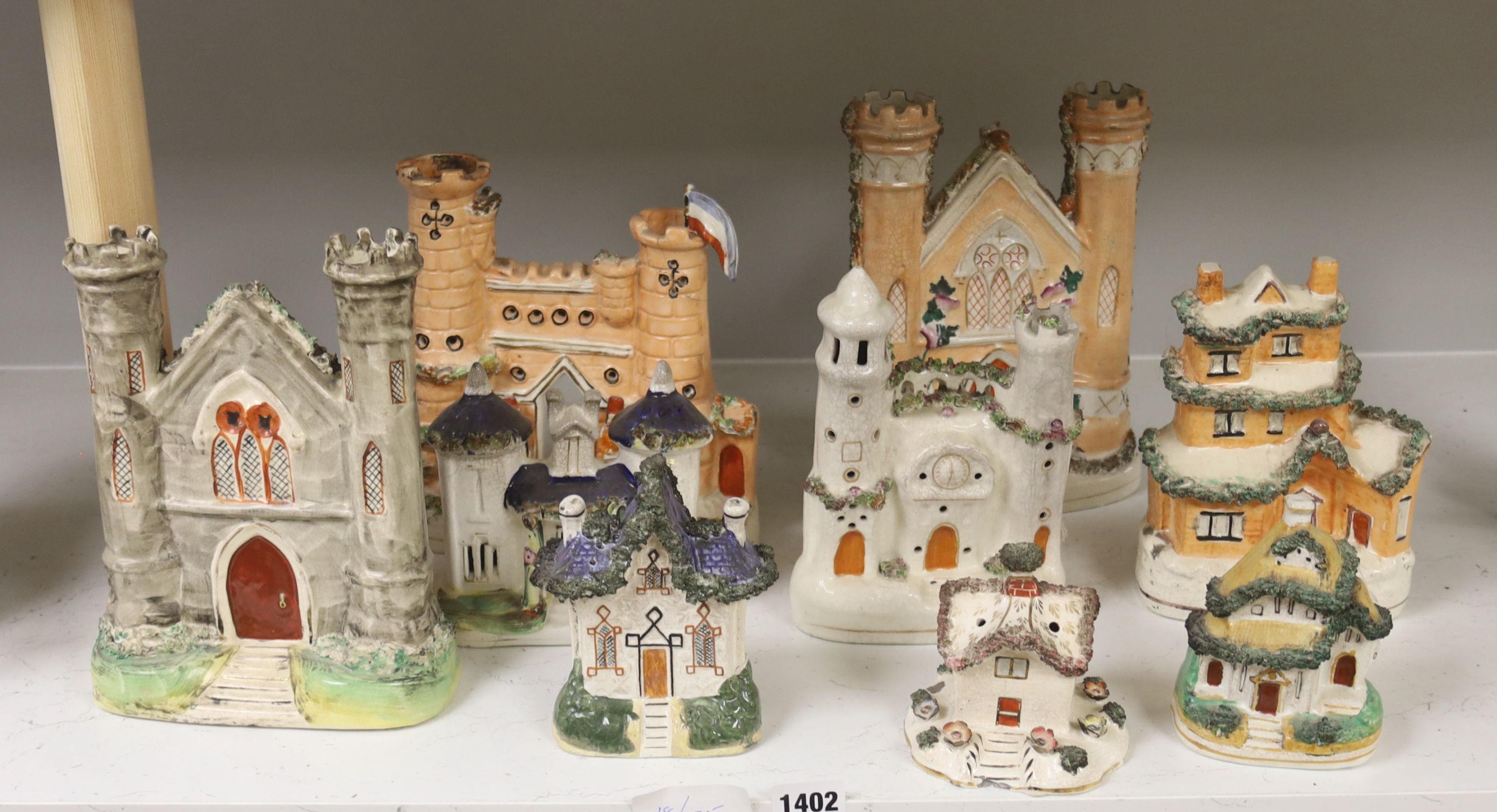 A collection of architectural Staffordshire pottery groups, tallest 22cm