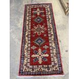 A Kazak style red ground runner, 200 x 84cm