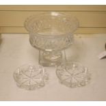 A large and heavy clear cut glass pedestal bowl, 20cm high, and two finger bowls