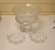 A large and heavy clear cut glass pedestal bowl, 20cm high, and two finger bowls