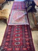 A Bokhara red ground runner, 305 x 80cm, together with a smaller Kashan style rug