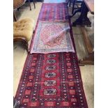 A Bokhara red ground runner, 305 x 80cm, together with a smaller Kashan style rug