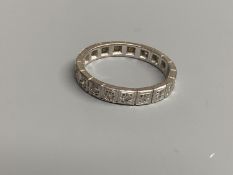 A modern white metal and diamond chip set full eternity ring, total carat weight approx. 0.35ct,
