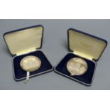Two sterling silver limited edition 'Man's First Moon Landing' commemorative medals, cased