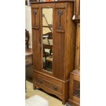 An early 20th century Arts & Crafts mirrored walnut wardrobe, length 96cm, depth 39cm, height 188cm