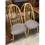 A set of four Ercol light beech comb back Windsor dining chairs