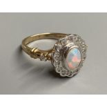 A modern 9ct gold, white opal and diamond chip set cluster ring, with diamond set shoulders, size O,
