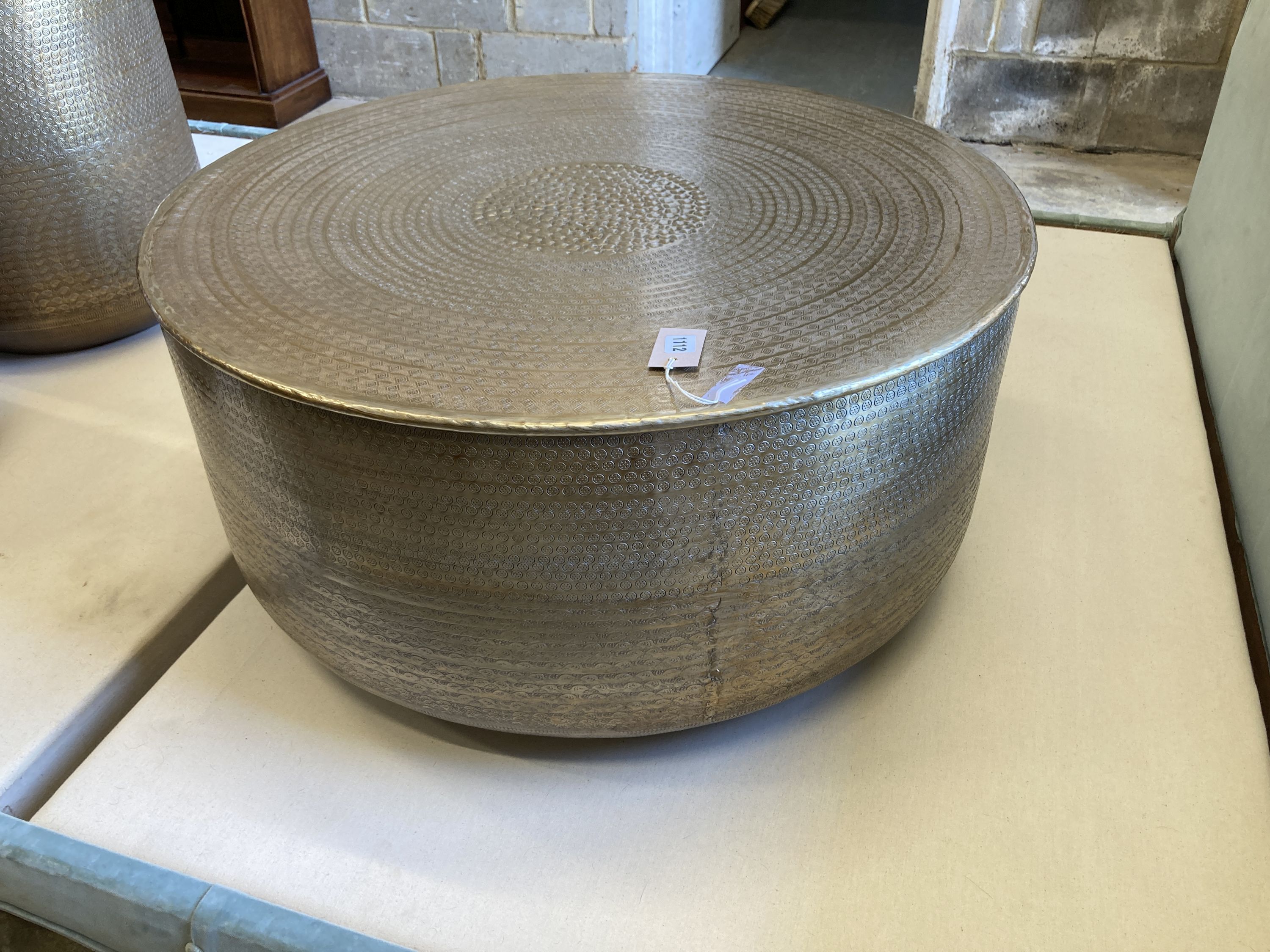 A contemporary Indian brass drum coffee table, 79cm diameter