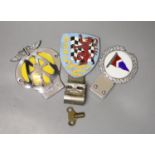 A British Automobile Racing Club car badge, an AA badge and one other