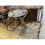 A pair of painted wrought iron garden rocking chairs together with a circular wrought iron folding