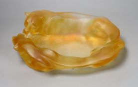 An amber glass dish with a recumbent lioness, signed, 24cm wide, apocryphal Daum mark