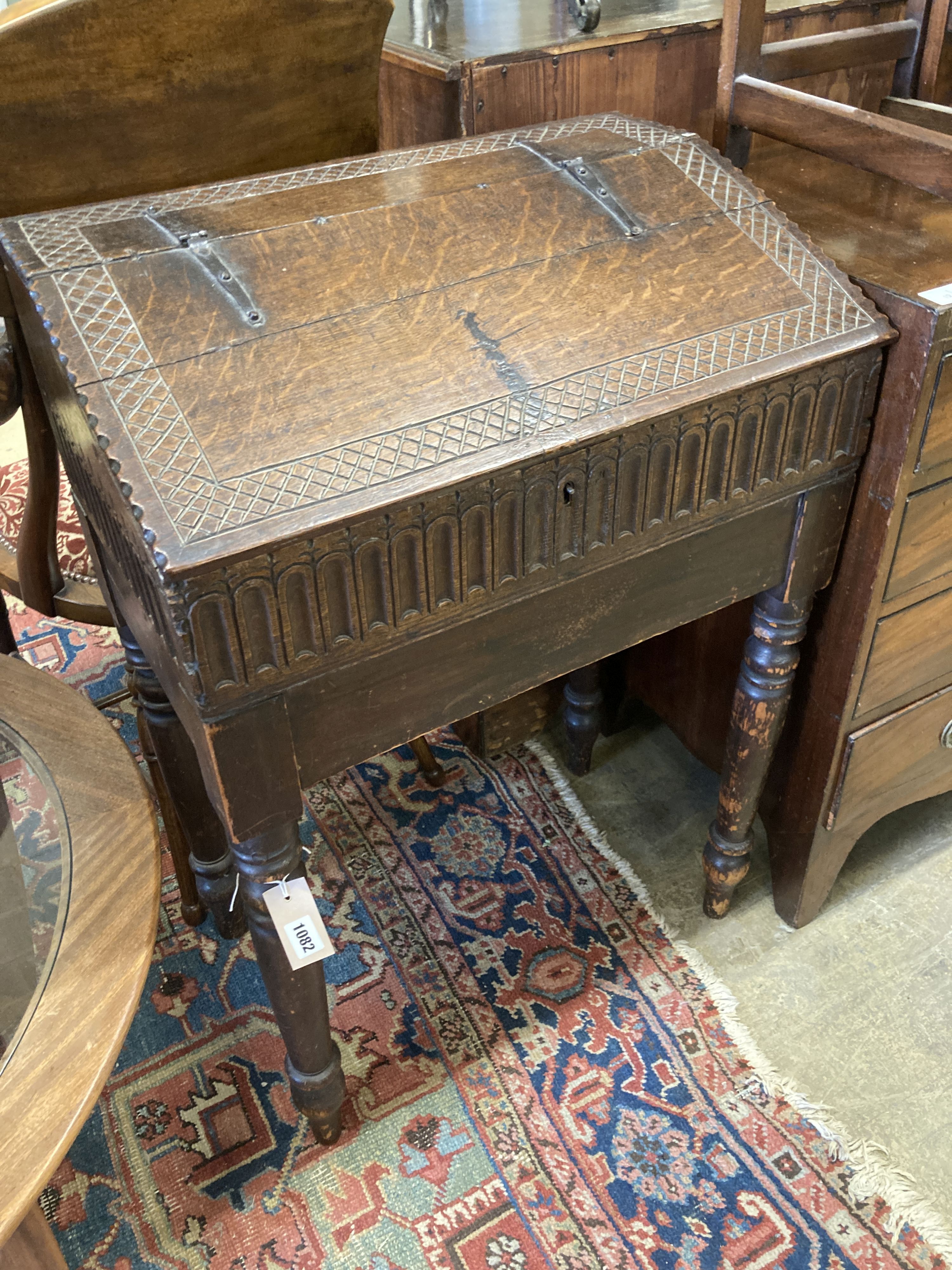 A 17th century oak slant front bible box, raised on a stand, width 61cm, depth 37cm, height 87cm