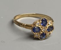 A modern 9ct gold, sapphire and diamond cluster ring, size O, gross 2.2 grams.