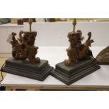 A pair of carved walnut winged griffin table lamps, 40cm high excl. light fitting